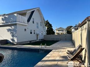 Long Beach house for rent - A white house with a pool in the backyard.