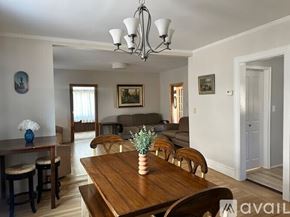 Long Beach house for rent - A dining room with a wooden table and chairs.