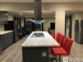 Antioch apartment for rent - A modern kitchen with a large island and red chairs.