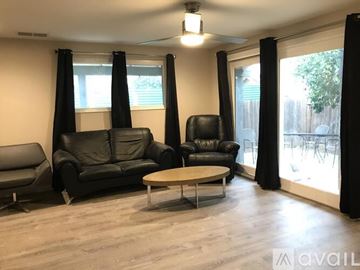 Antioch apartment for rent - A living room with black leather furniture and a wooden coffee table.