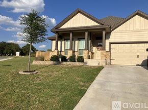 Burnet house for rent - A house with a garage and a tree in front.