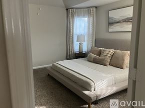 Burnet house for rent - A bedroom with a large bed and a painting on the wall.