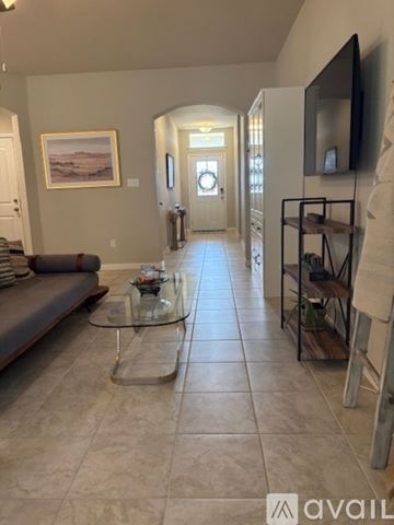 Burnet house for rent - A living room with a couch, coffee table, and a painting on the wall.