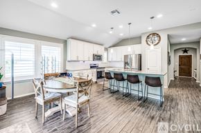 Schertz house for rent - A modern kitchen with a dining table and chairs.