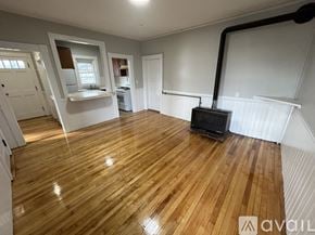Gardner apartment for rent - A room with wooden flooring and a black pipe running along the wall.