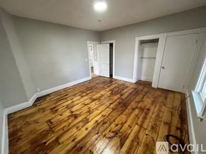 Gardner apartment for rent - A room with wooden flooring and white walls.