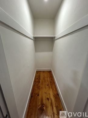 Gardner apartment for rent - A long hallway with wood floors and white walls.