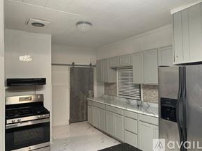 Magnolia house for rent - A kitchen with a stove top oven and a refrigerator.