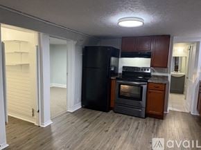 Berwyn apartment for rent - A room with wooden flooring and a window with blinds.