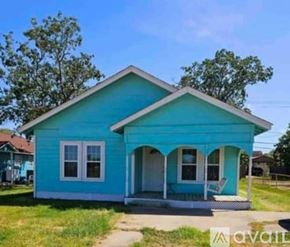 Freeport house for rent - A blue house with a porch and a white door.
