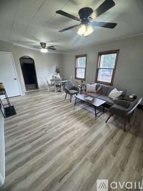 Salina house for rent - A living room with a couch, chairs, and a ceiling fan.