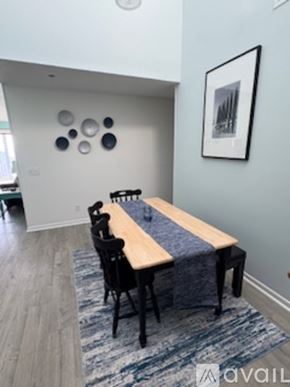 North Topsail Beach condo for rent - A dining room with a wooden table and chairs.