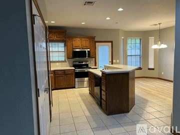 Moore house for rent - A kitchen with wooden cabinets and a large island.