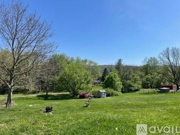 Knoxville house for rent - A living room with a grey couch and a wooden coffee table.