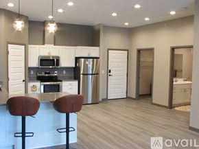 Minneapolis apartment for rent - A kitchen with a bar stool in front of it.