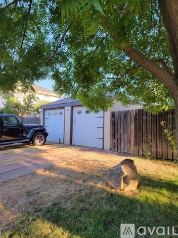 Sacramento townhouse for rent - A living room with a grey couch and a wooden coffee table.