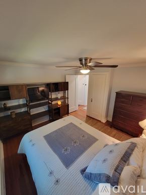 Sacramento townhouse for rent - A bedroom with a bed, dresser, and ceiling fan.