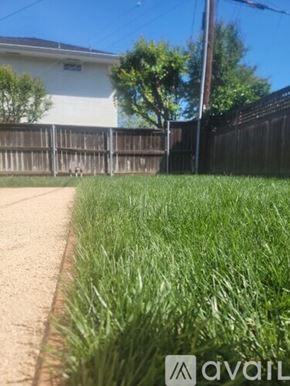 Sacramento townhouse for rent - A grassy area in front of a house with a fence.