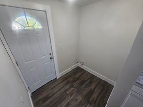 Lima house for rent - A room with a white door and wooden flooring.