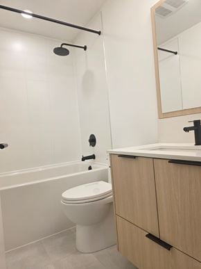 Surrey apartment for rent - A white toilet sits next to a bathtub in a bathroom.