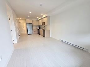 Surrey apartment for rent - A spacious kitchen with a refrigerator, microwave, and oven.