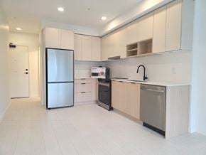 Surrey apartment for rent - A kitchen with a refrigerator, sink, and stove.