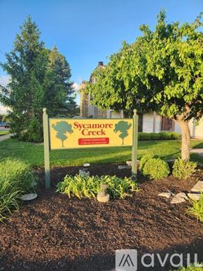 Fairborn condo for rent - A house with a red door and a stone chimney.