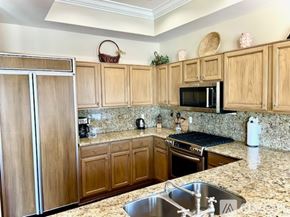 Scottsdale condo for rent - A kitchen with granite countertops and wooden cabinets.
