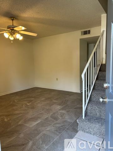 Slidell townhouse for rent - A kitchen with white appliances and brown cabinets.
