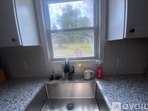 Oxon Hill apartment for rent - A kitchen with a window overlooking a backyard.