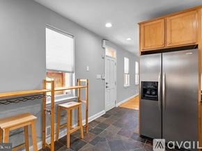 Baltimore townhouse for rent - A red brick building with a blue door and a yellow door.