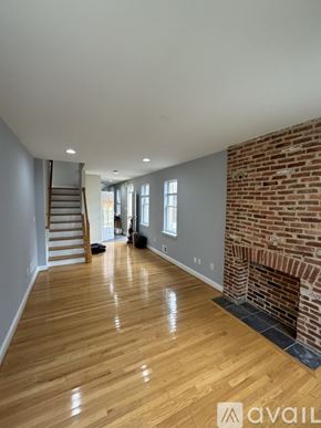 Baltimore townhouse for rent - A living room with a brick wall and a flat screen TV.
