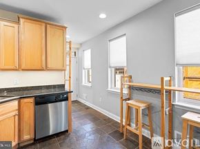Baltimore townhouse for rent - A room with a yellow door and a grey wall.