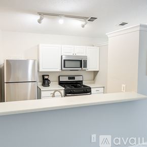 Austin apartment for rent - A kitchen with white cabinets and appliances.