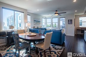 Oceanside townhouse for rent - A dining room with a round table and chairs.