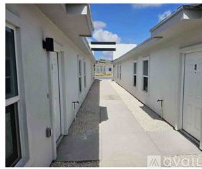 Edinburg apartment for rent - A long white building with a gravel path down the middle.