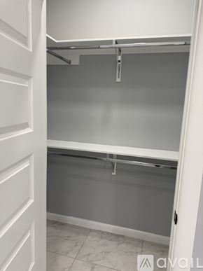 Edinburg apartment for rent - A white closet with a grey shelf and a white door.