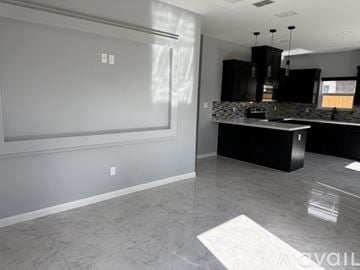 Edinburg apartment for rent - A kitchen with a black counter and a white wall.