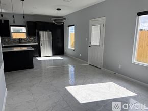 Edinburg apartment for rent - A spacious kitchen and living room with a marble floor and a view of the outdoors through the windows.