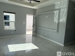 Edinburg apartment for rent - A spacious room with a marble floor and a ceiling fan.