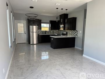 Edinburg apartment for rent - A kitchen with a marble floor and a refrigerator in the middle.