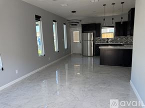 Edinburg apartment for rent - A kitchen with a marble floor and a refrigerator in the middle.
