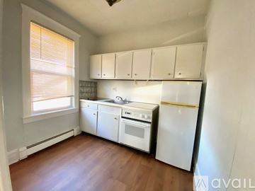 Highland Park apartment for rent - A kitchen with white appliances and wooden floors.