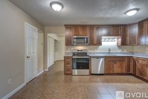 Blacksburg townhouse for rent - A kitchen with wooden cabinets and a tiled floor.