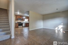 Blacksburg townhouse for rent - A living room with a staircase on the left side.