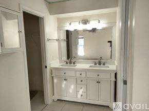 Flagler Beach house for rent - A bathroom with a white vanity and a mirror above it.