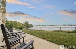 Alexandria condo for rent - A balcony with two chairs and a table overlooking a body of water.