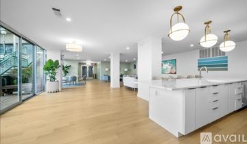 Alexandria condo for rent - A spacious kitchen and living room with white cabinets and wooden floors.