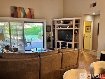 Palm Springs condo for rent - A living room with a brown couch and a television.