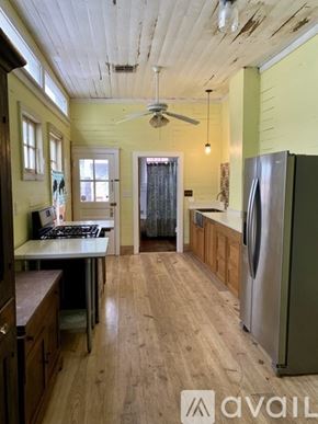 New Orleans apartment for rent - A kitchen with wooden floors and a stainless steel refrigerator.